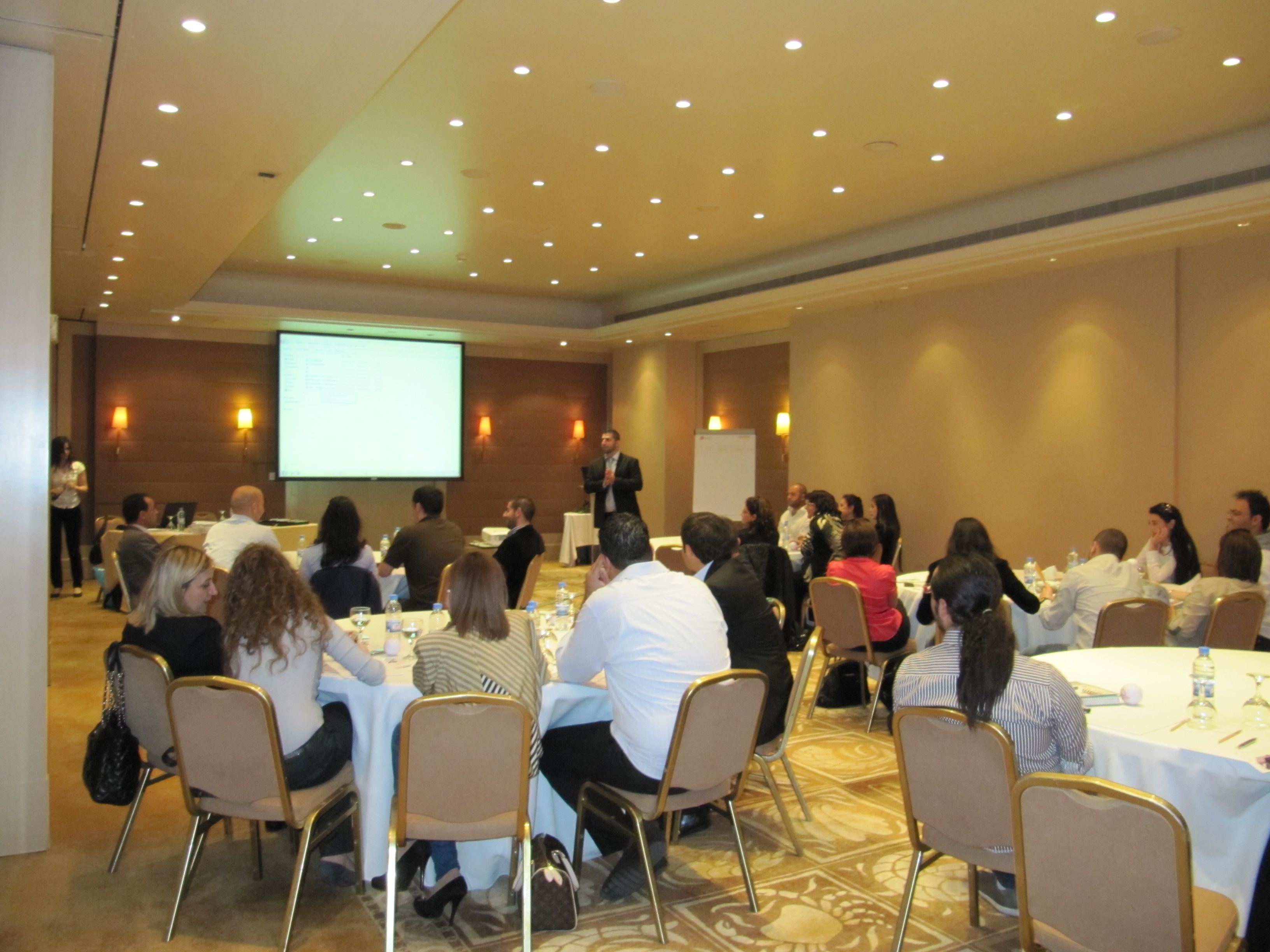 Corporate HR workshop with participants and presenter.